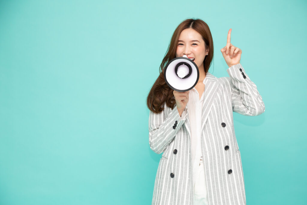 拡声器をもって注意を促す女性