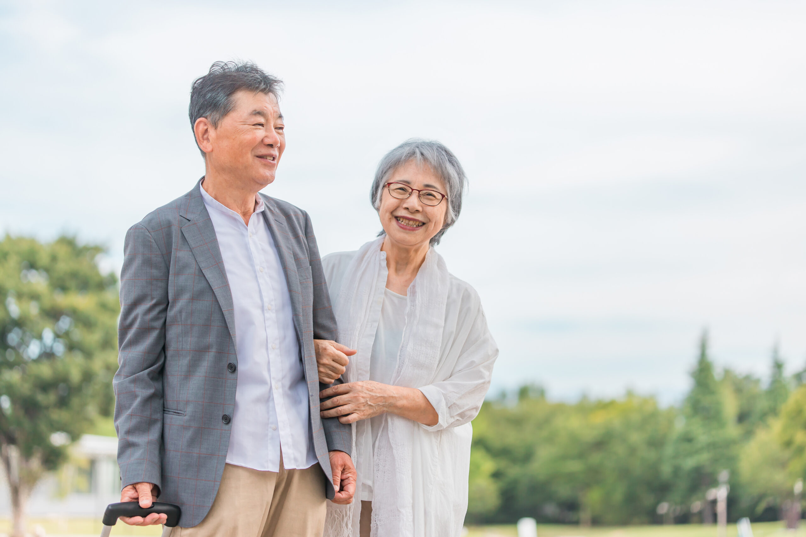 腕を組みながら楽しそうに話すシニア夫婦